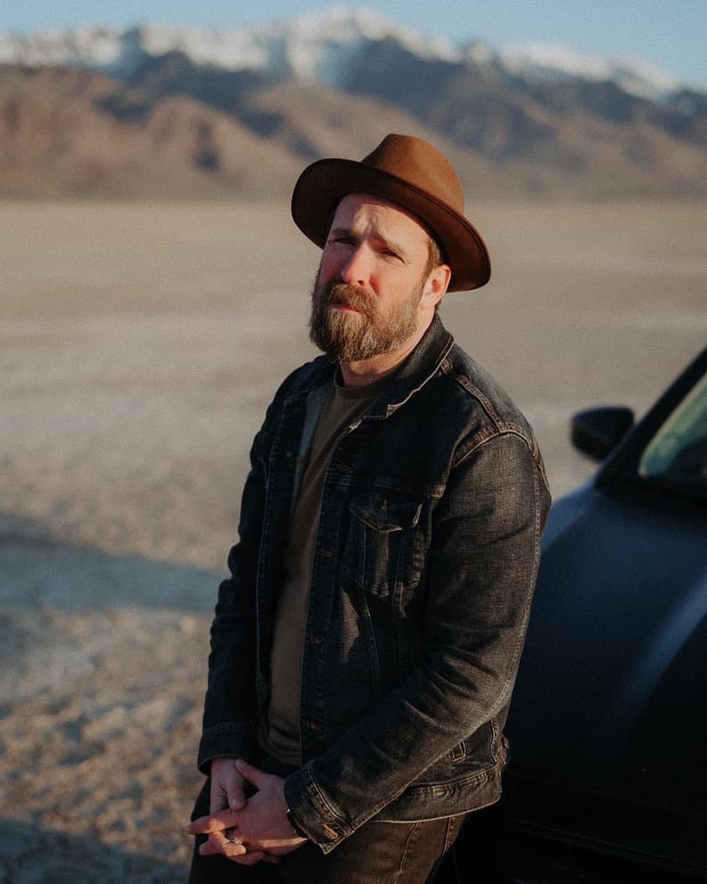 Mark Gowen standing in the desert with mountains behind him