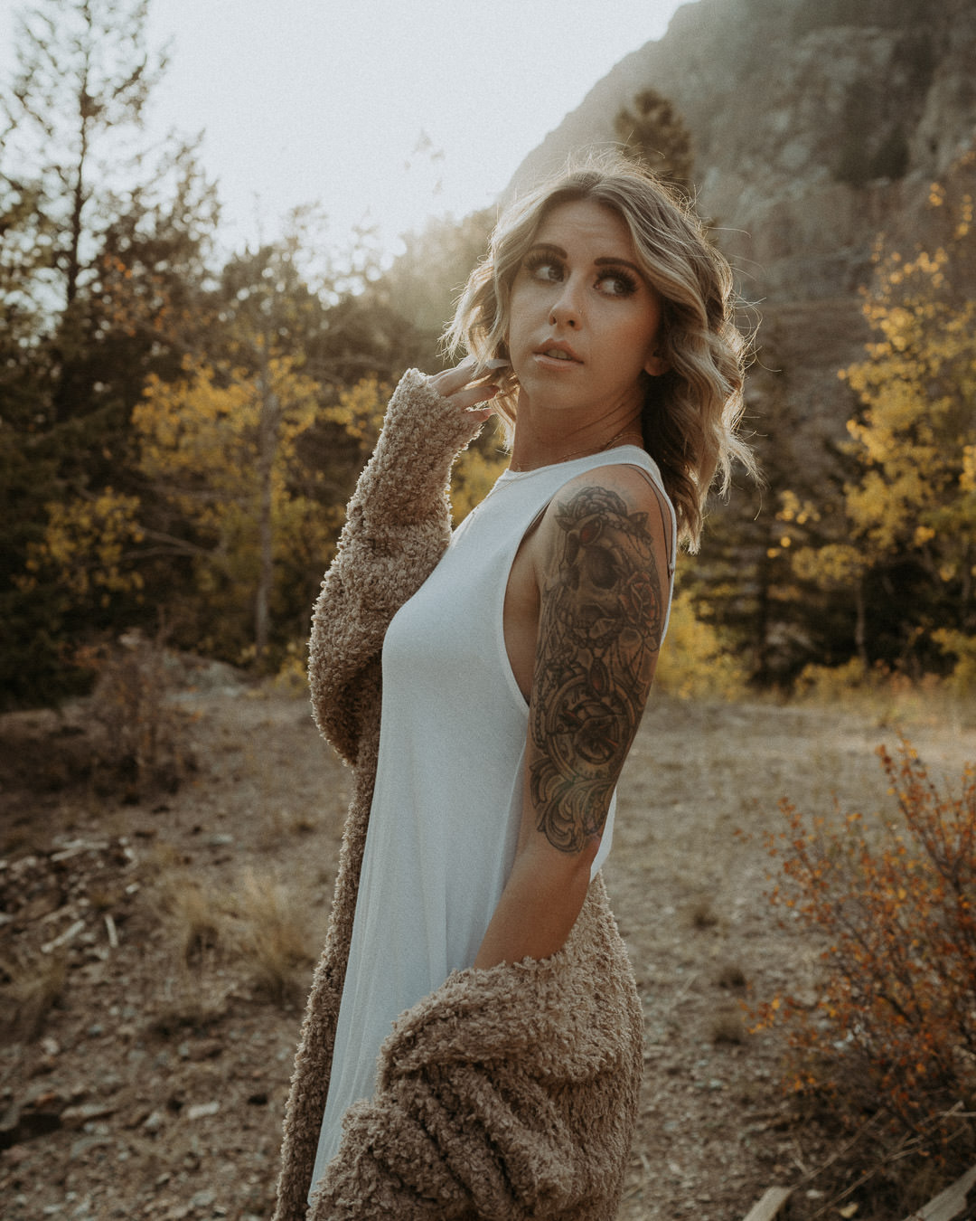 A woman looking over her shoulder in soft evening light