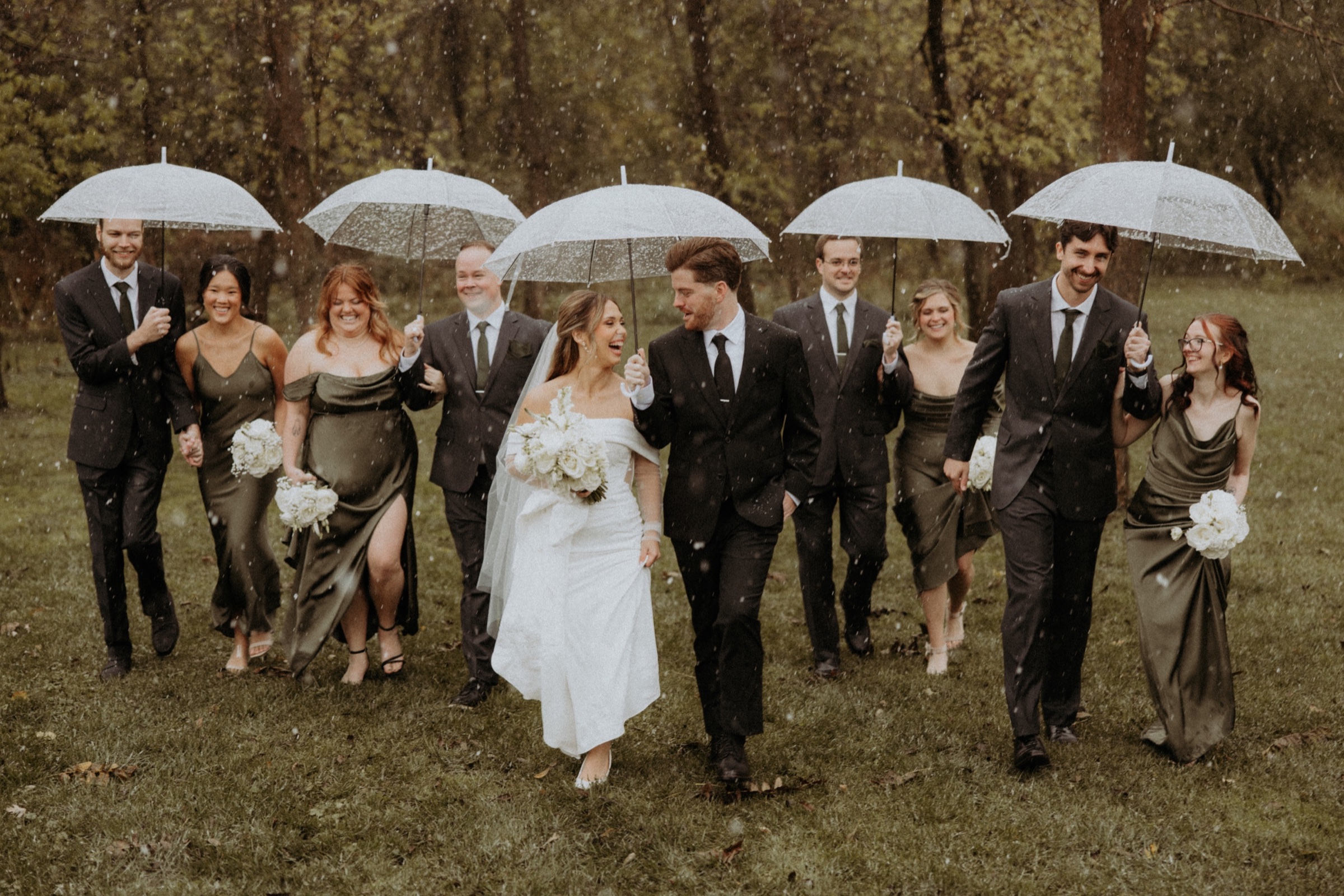 Wedding party laughing in the rain