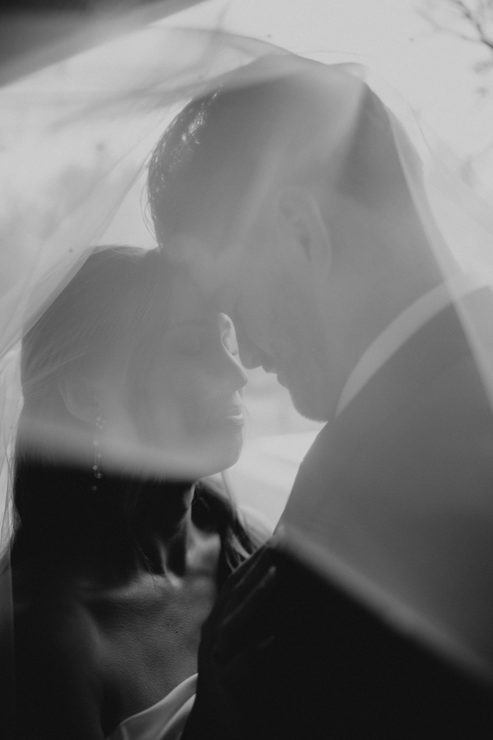 Black-and-white portrait beneath a veil